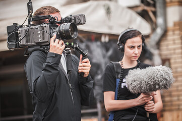 Behind the scenes. Cameraman shooting film scene with camera