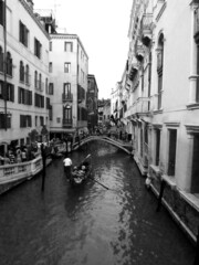 Gondola travelling through canal in Venice, Italy