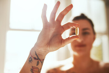 Medicinal help for your health. Shot of a woman taking a pill during her morning routine at home. - obrazy, fototapety, plakaty