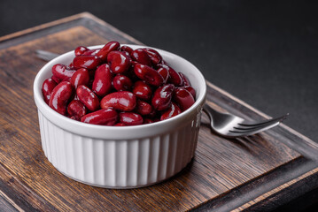 Canned red kidney beans in white bowl on a table