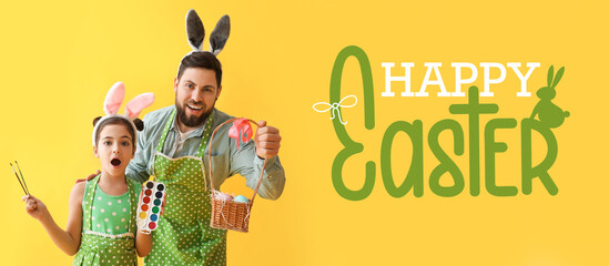 Little girl, her father with Easter eggs, paints and brushes on yellow background