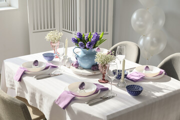 Stylish table setting for Easter celebration in room