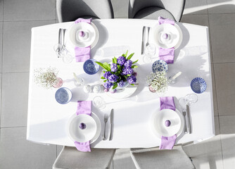 Festive table setting with beautiful flowers for Easter celebration