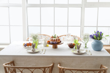 Easter cake and eggs on served dining table in light room