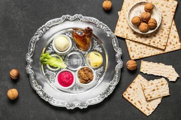Fototapeta na wymiar Passover Seder plate with traditional food, walnuts and matza on dark background