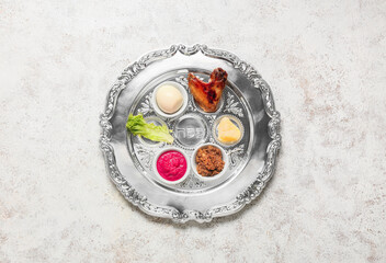 Passover Seder plate with traditional food  on light background