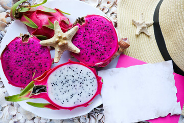 Exotic fruits. dragon fruit and mango on a background of seashells