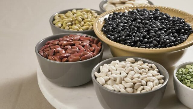 Nutrition, Healthy diet, plant based vegan protein sources. Rotating white lima beans, peas, kidney beans, black beans, soybeans.