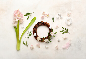 Fototapeta na wymiar Easter wreath, eggs and floral decor on light background