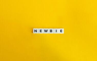 Newbie Word on Letter Tiles on Yellow Background. Minimal Aesthetics.