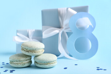 Delicious macaroons on color background. International Women's Day celebration