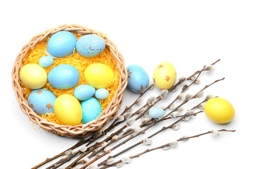 Fototapeta na wymiar Nest with painted Easter eggs and pussy willow branches on white background