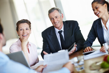 Enjoying a stimulating business discussion. A group of businesspeople having a meeting and discussing business.
