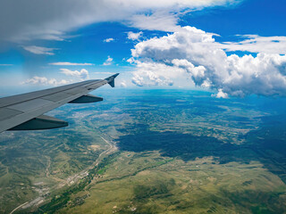 Fototapeta premium Aerial view of mountain landscape, view from window seat in an airplane