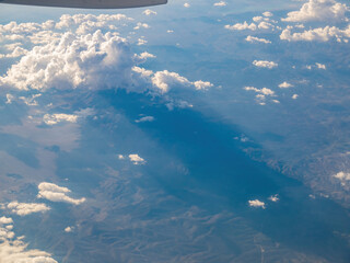 Fototapeta na wymiar Aerial view of mountain landscape, view from window seat in an airplane