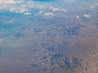 Aerial view of mountain landscape, view from window seat in an airplane