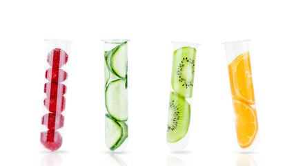 Slices of cucumber, kiwi, orange and raspberries in test tubes isolated on white. Natural...