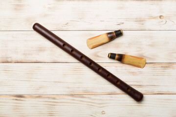 Armenian national musical instrument duduk on wooden background. Top view