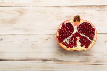 Fresh juicy pomegranate on white wooden background, top view
