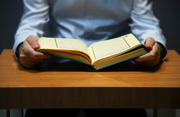 reading holy book. open quran on table. 