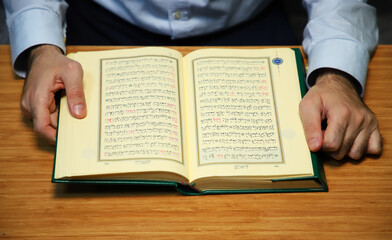 reading holy book. open quran on table. 