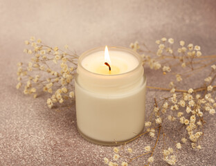 Soy wax candle in white glass on a beautiful background