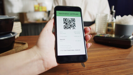 QR code, covid vaccination passport control close-up. Scanning coronavirus electronic medical certificate on smartphone in cafe or restaurant, green zone.