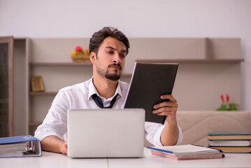 Young male employee working from home during pandemic
