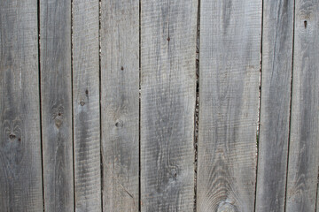 Weather-beaten wooden board fence.