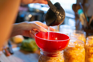 Funneling apple filling into canning jar