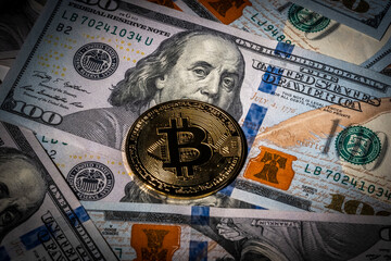 Symbolic digital coin of bitcoin on one hundred banknote dollars. Exchange gold bitcoin for cash money. Cryptocurrency on US bills. Modern payment method. Decentralized Savings, investments concept.