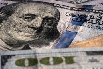 Closeup on Benjamin Franklin portrait on a one hundred US American paper banknote currency. Money for exchange. Global recession and inflation in the United States of America