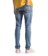 Fashionable young man in stylish jeans on white background