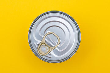 Unopened Tin Can with Blank Edge on Yellow Background. Canned Food. Aluminum Can for Safe and Long...