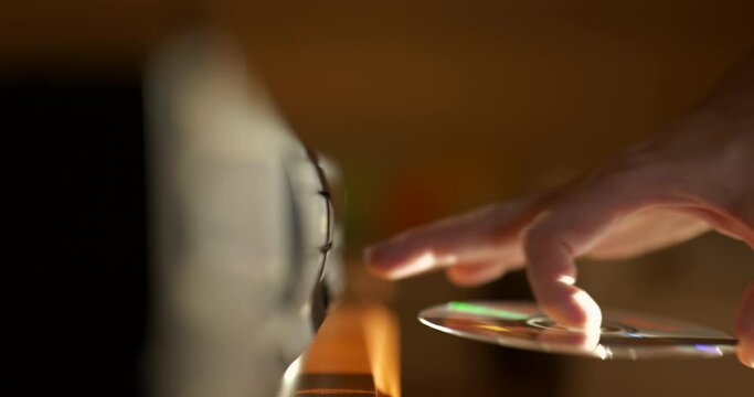 Man Loading CD Into a Compact Disc player