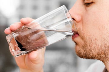 Close up man is drinking dirty water. 