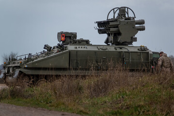 Fototapeta na wymiar British Army Alvis Stormer Starstreak CVR-T tracked armoured vehicle equipped with short range air defense high-velocity missile system in action on a military exercise, Wiltshire UK