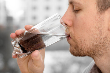 Close up man is drinking dirty water. 