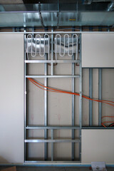 behind the panels of a drywall run cables - obrazy, fototapety, plakaty