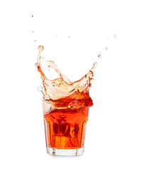 Glass of tasty Manhattan cocktail with splashes isolated on white background