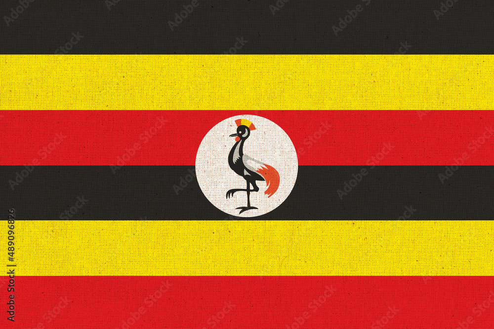 Wall mural Flag of Uganda. Ugandan flag on fabric surface. Fabric texture