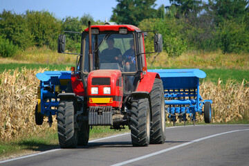 Obraz premium Tractor with seeder in the field
