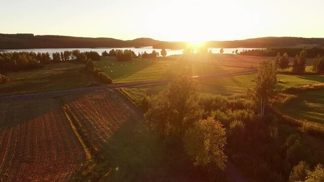 Beautiful sunset over lake and fields