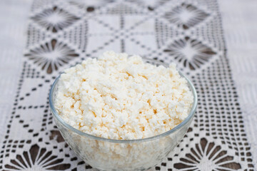 farm fat cottage cheese in a bowl on the rural table