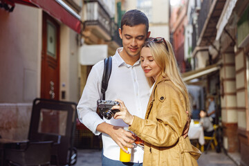 Charming couple looking at the camera standing on street