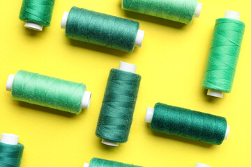 Different sewing threads on yellow background