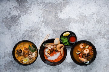 Tom Yum and Tom Kha traditional Thai soups with seafood, chicken, coconut milk and hot spices