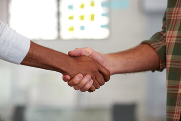 Its great to finally meet you. Two casual men shaking hands.
