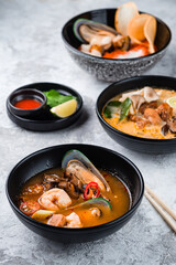 classic tom yam Thailand dish. Traditional spicy Thai soup Tom Yum with shrimp and seafood in ceramic bowl