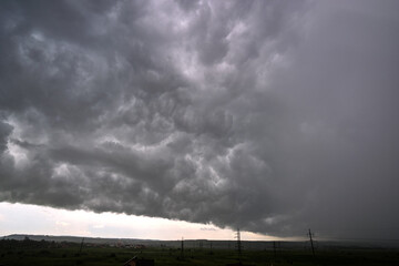 Landscape of dark ominous clouds forming on stormy sky during heavy thunderstorm